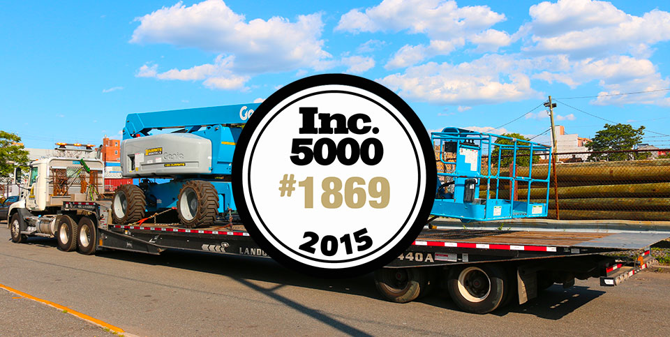2015 INC 5000 badge and boom lift being transported on truck